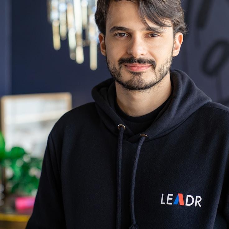 Jordan Lee, Lead Design Curator at MeadowStudioPort, reviewing corporate floral arrangements